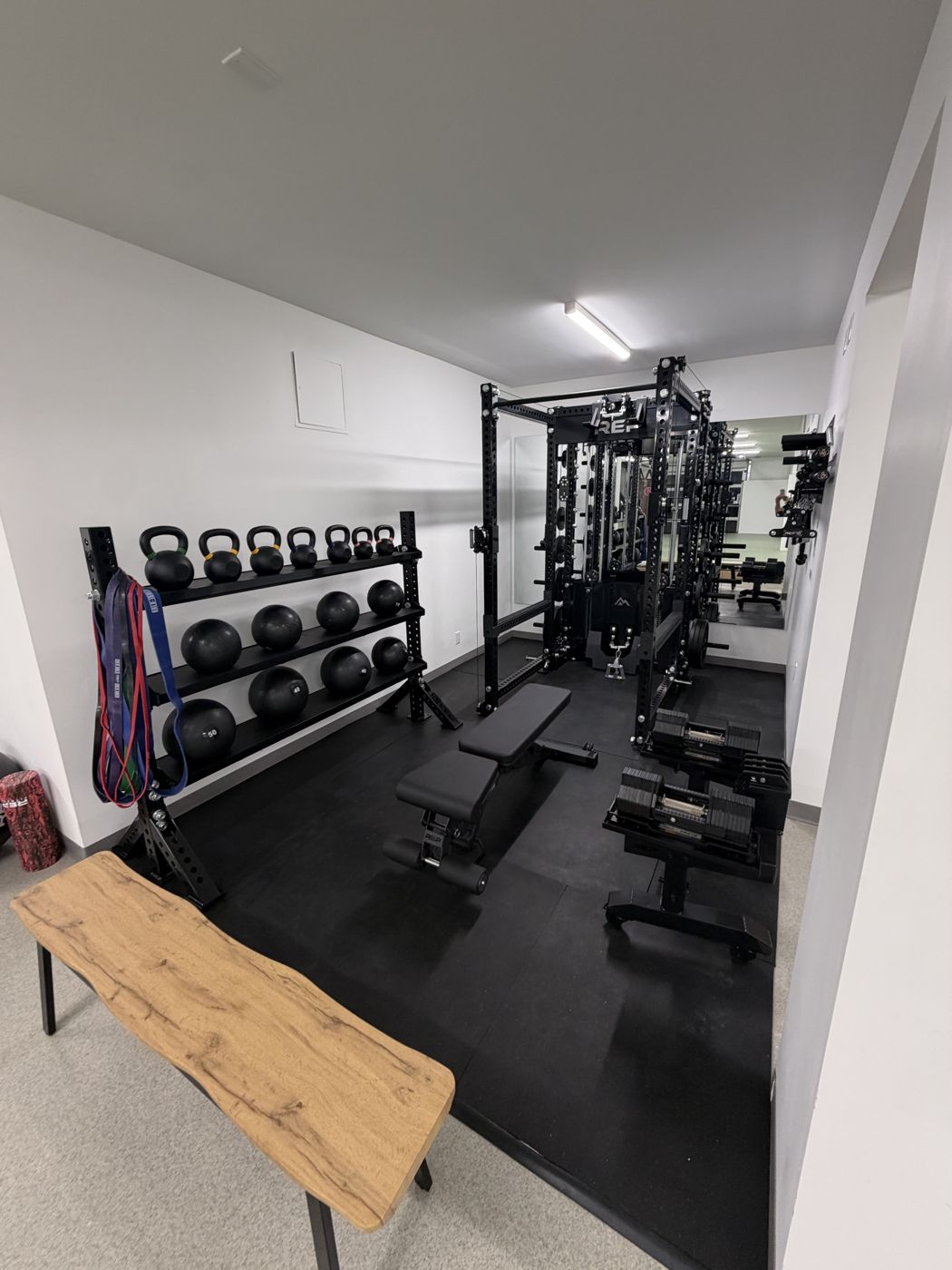 Strength room with power rack, dumbbells and kettlebells